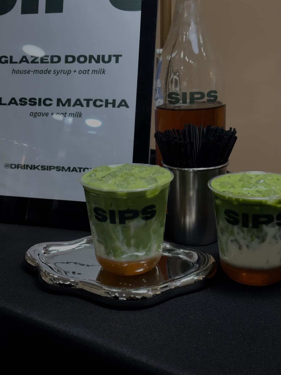 Glazed Donut matcha in a SIPS cup on a chrome tray