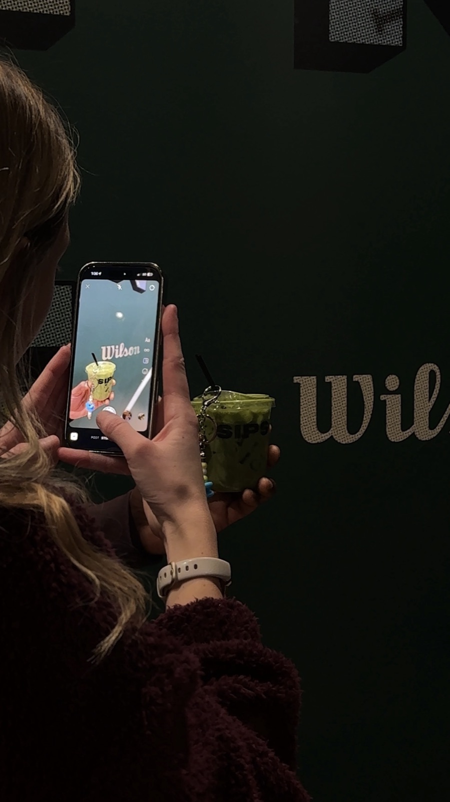 A guest filming their SIPS matcha at the Wilson pop-up